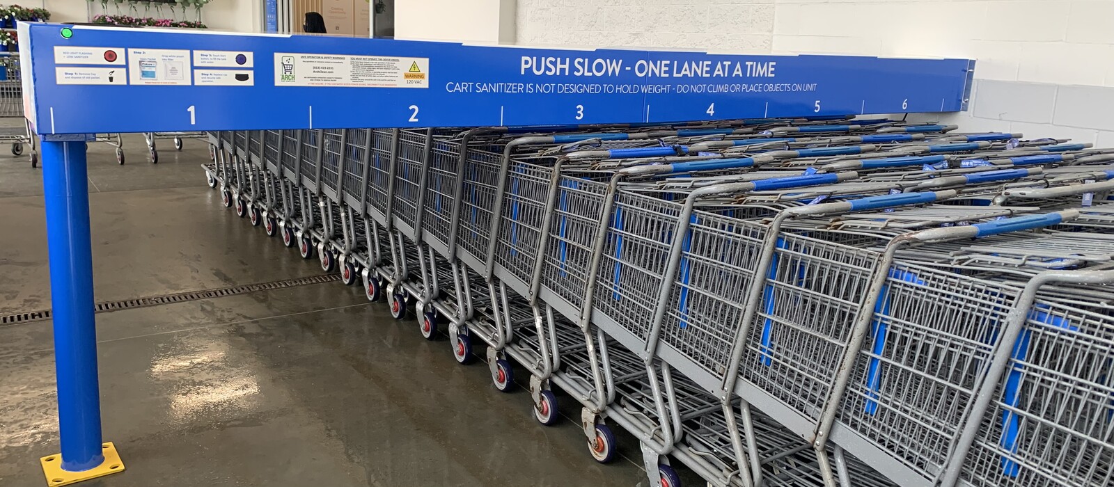 2022 ArchClean blue six-lane cart sanitizer with rows of shopping carts